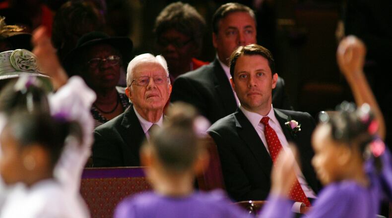Former President Jimmy Carter and Georgia Democratic candidate for governor Jason Carter watch a youth dance performance Sunday, Oct. 12, 2014 at Mt. Zion Baptist Church in Albany, Ga. After an absence of four decades, the former president is returning to the campaign trail this year on behalf of his grandson, Jason, whos challenging incumbent Republican Gov. Nathan Deal. (AP Photo/Phil Sears)