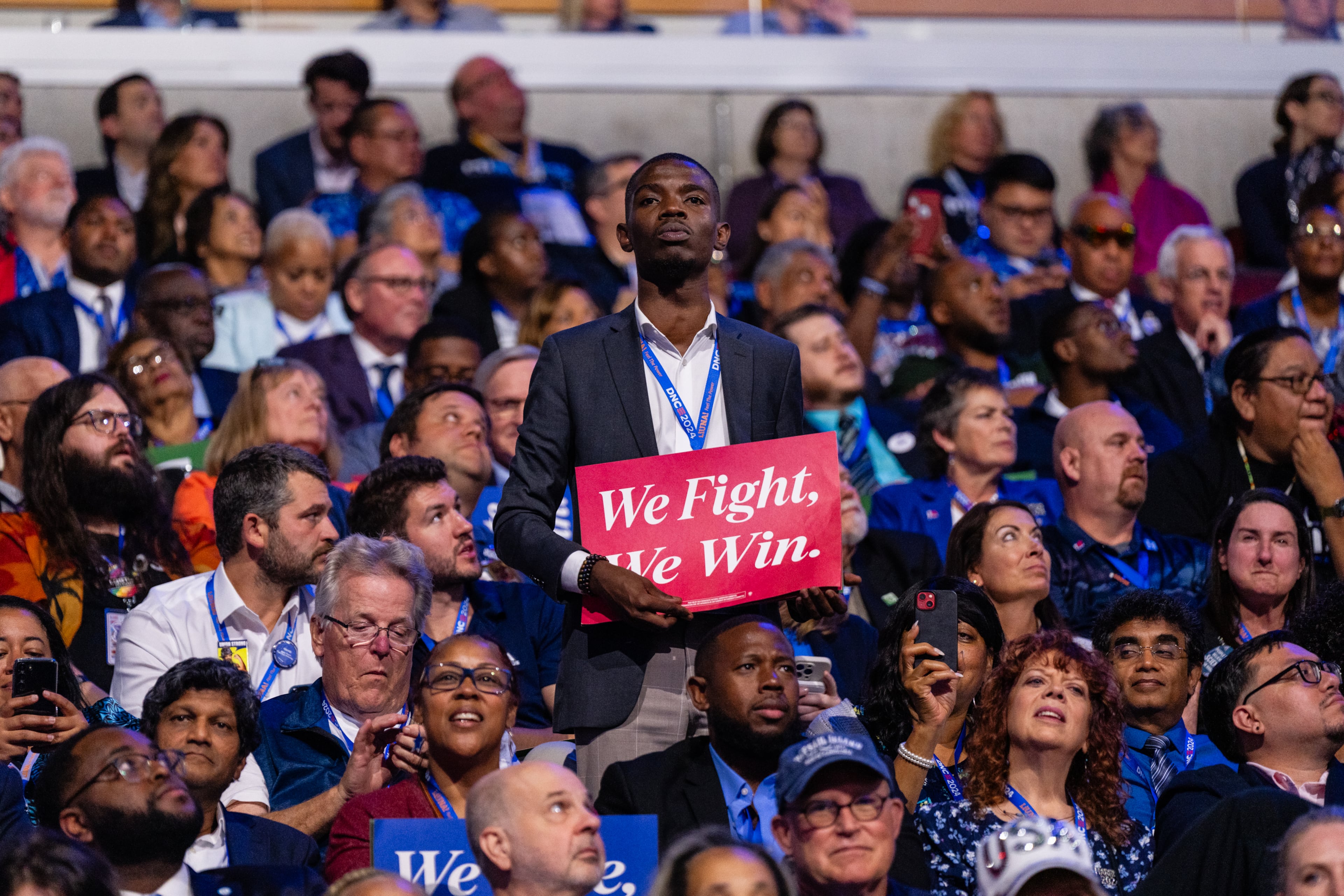 A delegate held a sign at the 2024 Democratic National Convention in Chicago. (Eric Lee/The New York Times)
