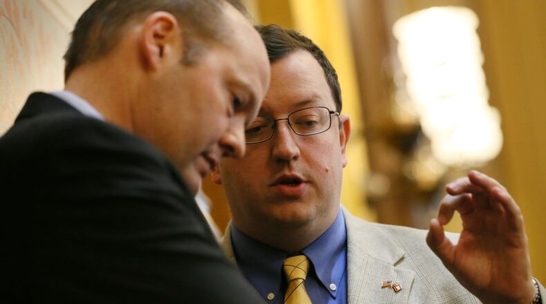 March 26, 2015 - Atlanta - Senator Joshua McKoon (right), sponsor of SB 129, the religious liberty bill, confers with Rep. Barry Fleming, R - Harlem, after he used his point of privilege during this morning's senate session to promote his bill, saying that in spite of the threatened loss of millions of dollars in convention business, having the protections are worth it. Fleming is a member of the House Judiciary committee considering the bill. BOB ANDRES / BANDRES@AJC.COM State Sen. Josh McKoon (right), with Rep. Barry Fleming, R-Harlem. AJC file/Bob Andres, bandres@ajc.com