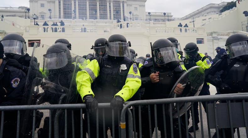 Police try to hold back protesters who gather to storm the U.S. Capitol and halt a joint session of the 117th Congress on Jan. 6 in Washington, D.C.