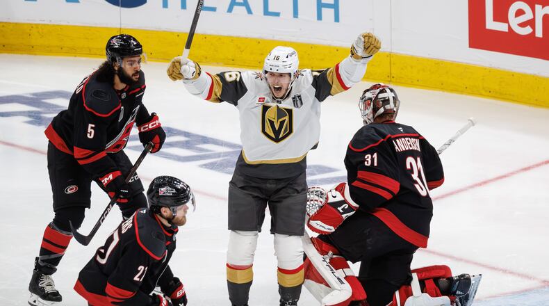 Vegas Golden Knights' Pavel Dorofeyev (16) celebrates between Carolina Hurricanes' Jalen Chatfield (5), Alexander Nikishin (21), and goaltender Frederik Andersen (31) after a goal in the second period of Game 1 of the NHL hockey Stanley Cup Final series in Raleigh, N.C., Tuesday, June 2, 2026. (AP Photo/Ben McKeown)