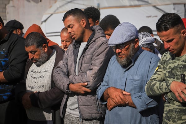 Nashat Seiam, second from right, joins relatives and friends in prayer over the body of his granddaughter Ahlam, who was just days away from her first birthday, during her funeral after she was killed by an overnight Israeli airstrike on her home in Khan Younis, southern Gaza Strip, on Wednesday, April 16, 2025,.(AP Photo/Mariam Dagga)
