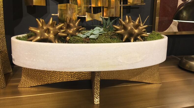 Small decorative metallic objects placed on moss makes a bold statement. (Design Recipes)