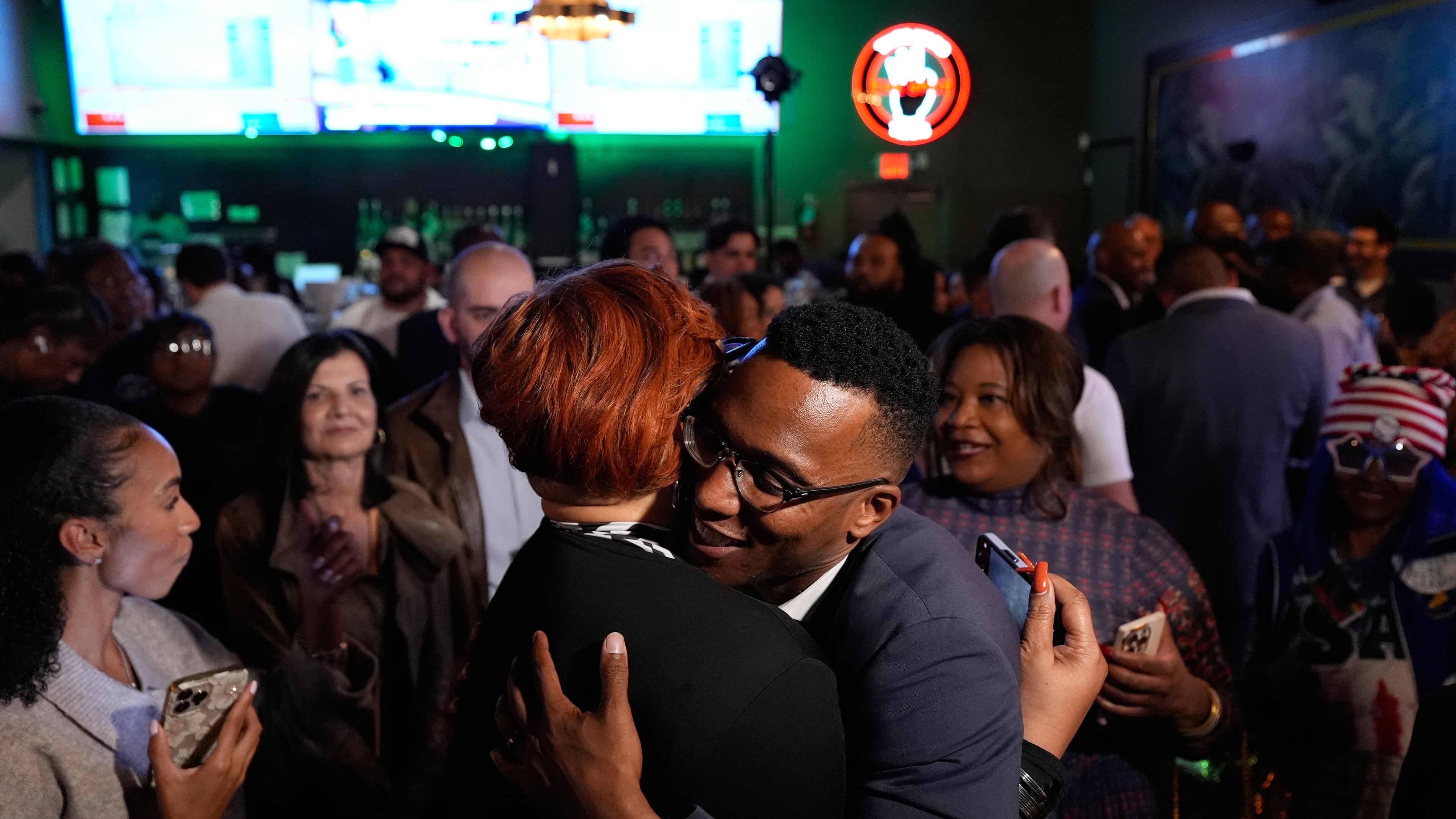 Democratic 18th Congressional District candidate Christian Menefee, right, hugs an attendee during an election night watch party on Tuesday, Nov. 4, 2025, in Houston. (AP Photo/Ashley Landis)