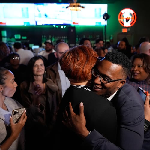 Democratic 18th Congressional District candidate Christian Menefee, right, hugs an attendee during an election night watch party on Tuesday, Nov. 4, 2025, in Houston. (AP Photo/Ashley Landis)
