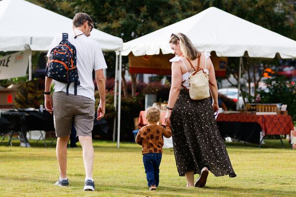 A family walks toward the food vendors during the Decatur Book Festival at First Baptist Church of Decatur on Saturday, Oct. 4, 2025. (Abbey Cutrer/AJC)