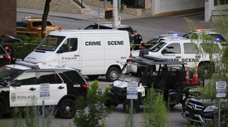 Police gather outside the Omni hotel on Sunday morning in downtown Austin, where two people are dead, including one person shot by police officers.