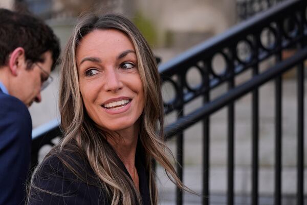 Karen Read chats with reporters while returning to court following the lunch break with her defense attorney Robert Alessi at her trial at Norfolk Superior Court, Tuesday, April 22, 2025, in Dedham, Mass. (AP Photo/Charles Krupa)