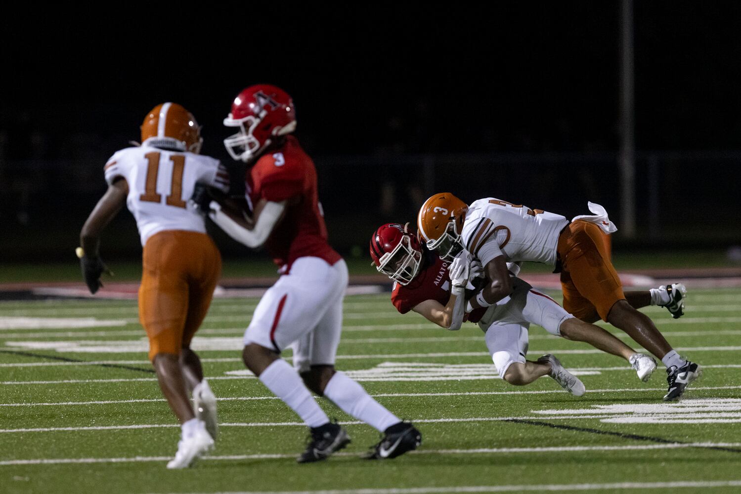 Allatoona’s Camden Phillips (10) is hit hard by a Kell tackler.  (Photo/Jenn Finch)