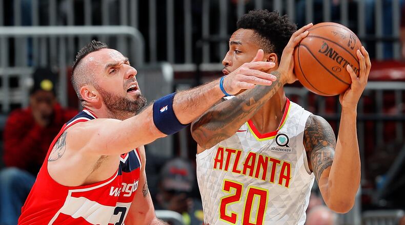 Marcin Gortat #13 of the Washington Wizards defends against John Collins #20 of the Atlanta Hawks at Philips Arena on December 27, 2017 in Atlanta, Georgia. (Photo by Kevin C. Cox/Getty Images)
