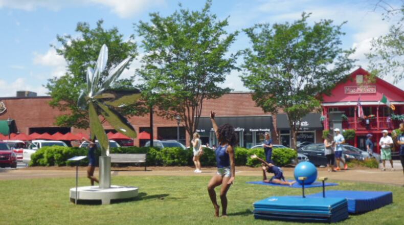 “Sentience” by Atlanta artist David Landis, surrounded by Element Circus Artists at Heart of Roswell Park. Vicki Griffin for the AJC
