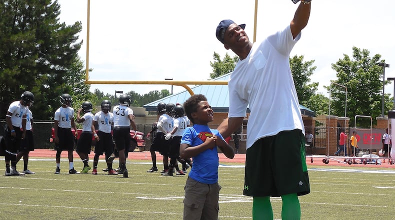 Carolina Panthers QB and Westlake High School alum Cam Newton poses for a selfie with a young superhero! Photo: Jennifer Brett