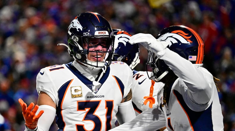 Denver Broncos safety Justin Simmons (31) celebrates his interception of Buffalo Bills quarterback Josh Allen (17) with teammate Tremon Smith (1) in the first quarter at Highmark Stadium Nov. 13, 2023, in Orchard Park, New York. (Andy Cross/The Denver Post/TNS)