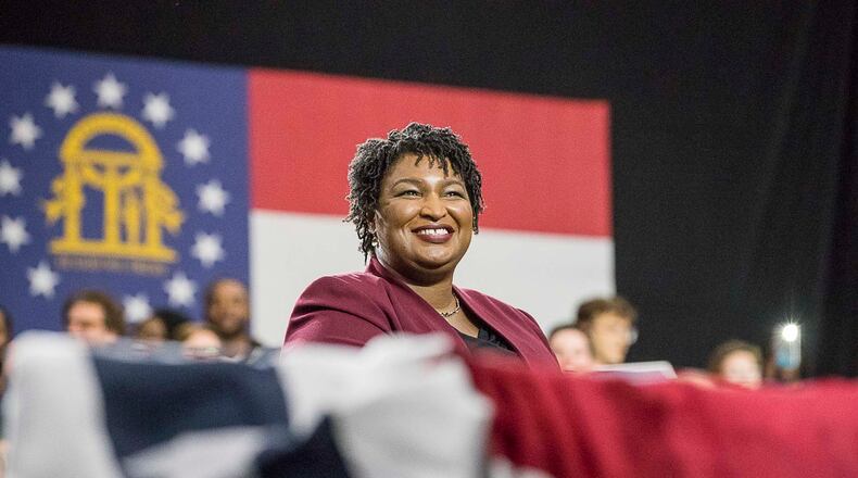 11/02/2018 -- Atlanta, Georgia -- Georgia Gubernatorial candidate Stacey Abrams listens as former President Barack Obama speaks during a rally for in Forbes Arena at Morehouse College, Friday, November 2, 2018. (ALYSSA POINTER/ALYSSA.POINTER@AJC.COM)