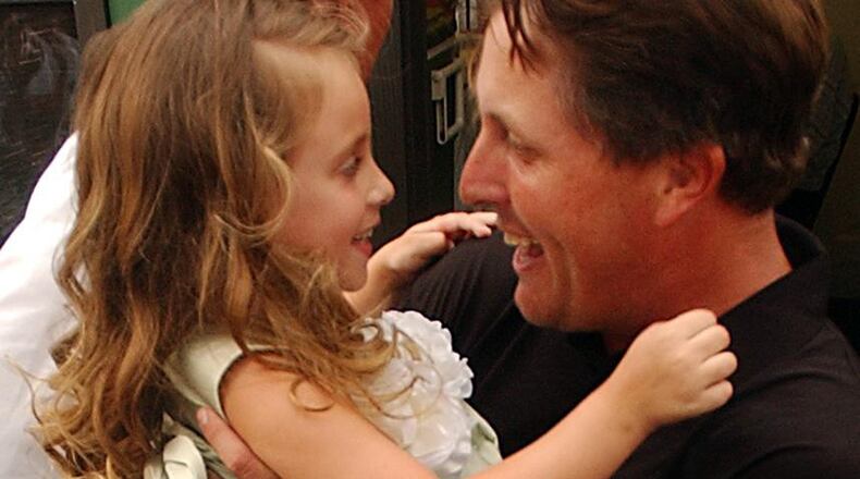 Daddy did it: Phil Mickelson celebrates his breakthrough 2004 Masters victory with his daughter, Amanda. (CURTIS COMPTON/AJC staff)