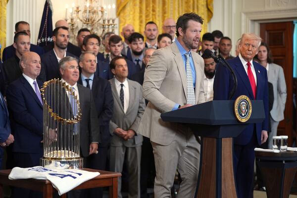 President Donald Trump, right, listens as Los Angeles Dodgers' Clayton Kershaw speaks during a ceremony to honor the Major League Baseball 2024 World Series Champion team in the East Room of the White House, Monday, April 7, 2025, in Washington. (AP Photo/Evan Vucci)