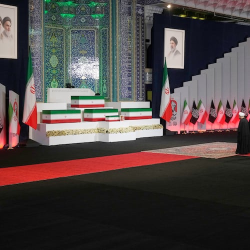 Iranian religious leaders and other mourners pay their respects before the coffins of slain Iranian Supreme Leader Ayatollah Ali Khamenei and members of his family during a viewing ceremony ahead of the dayslong funeral ceremonies at the Imam Khomeini Mosalla Grand Mosque in Tehran, Iran, Friday, July 3, 2026. (AP Photo/Vahid Salemi)