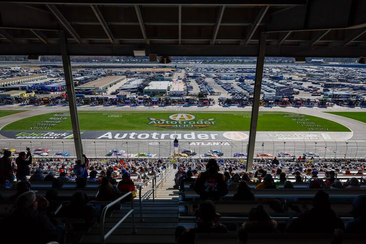 Fans watch cars race at the end of Stage 1 of the NASCAR Autotrader 400 at EchoPark Speedway on Sunday, Feb. 22, 2026, in Hampton, Ga. (Miguel Martinez/AJC)