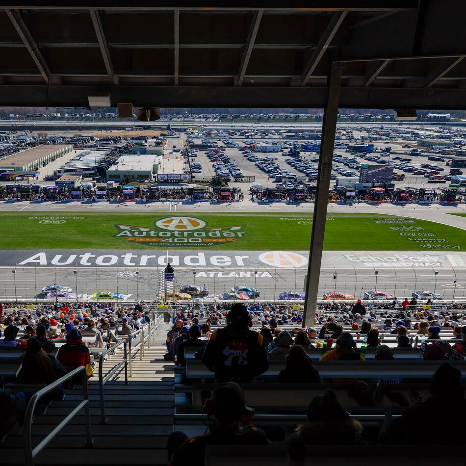 Fans watch cars race at the end of Stage 1 of the NASCAR Autotrader 400 at EchoPark Speedway on Sunday, Feb. 22, 2026, in Hampton, Ga. (Miguel Martinez/AJC)
