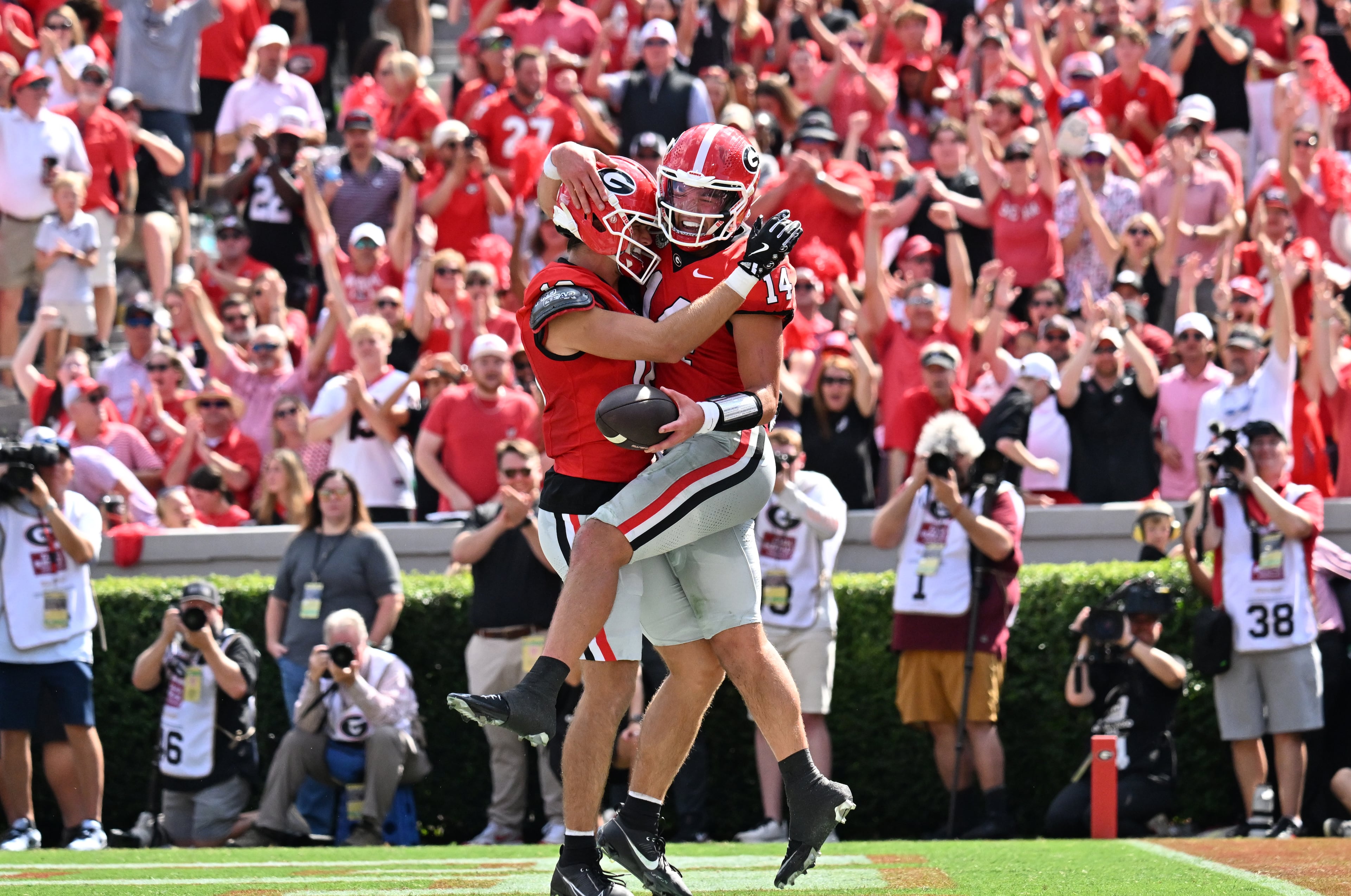 Georgia quarterback Gunner Stockton (14) celebrates with teammates after scoring a touchdown during the first half in an NCAA football game at Sanford Stadium, Saturday, August 30, 2025, in Athens. (Hyosub Shin / AJC)