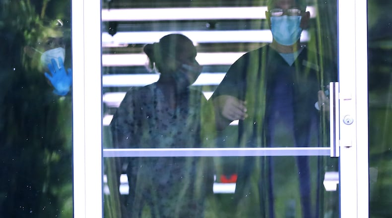 Nursing home inspectors cited Carrollton Manor nursing home in west Georgia for an infection-control violation during an inspection in March of 2020. Within the first five months of the pandemic state records showed 60 residents tested positive for Covid-19 and seven died from the virus. In this photo employees were seen working in a hallway at the facility in April 2020. Curtis Compton ccompton@ajc.com