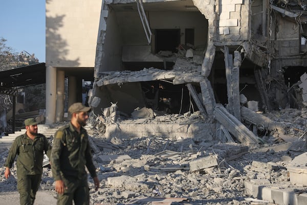 Soldiers inspect the damaged Syrian Defense Ministry building allegedly hit by several Israeli airstrikes, in Damascus, Syria, Wednesday, July 16, 2025. (AP Photo/Ghaith Alsayed)