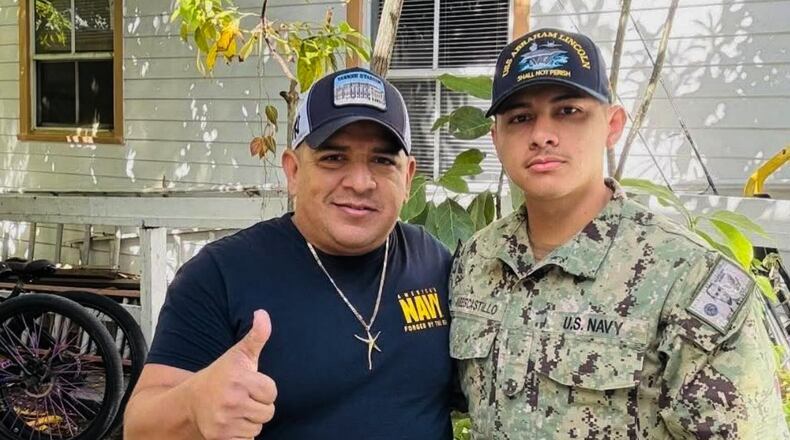 In this photo courtesy of Katherine Delgado shows her step-father Luis Manuel Aviles, left, and her brother Joshua Aviles stand outside their home in Oct. 2025, shortly before Joshua deployed on the USS Lincoln the following month in Key West, Fla. (Katherine Delgado via the AP)