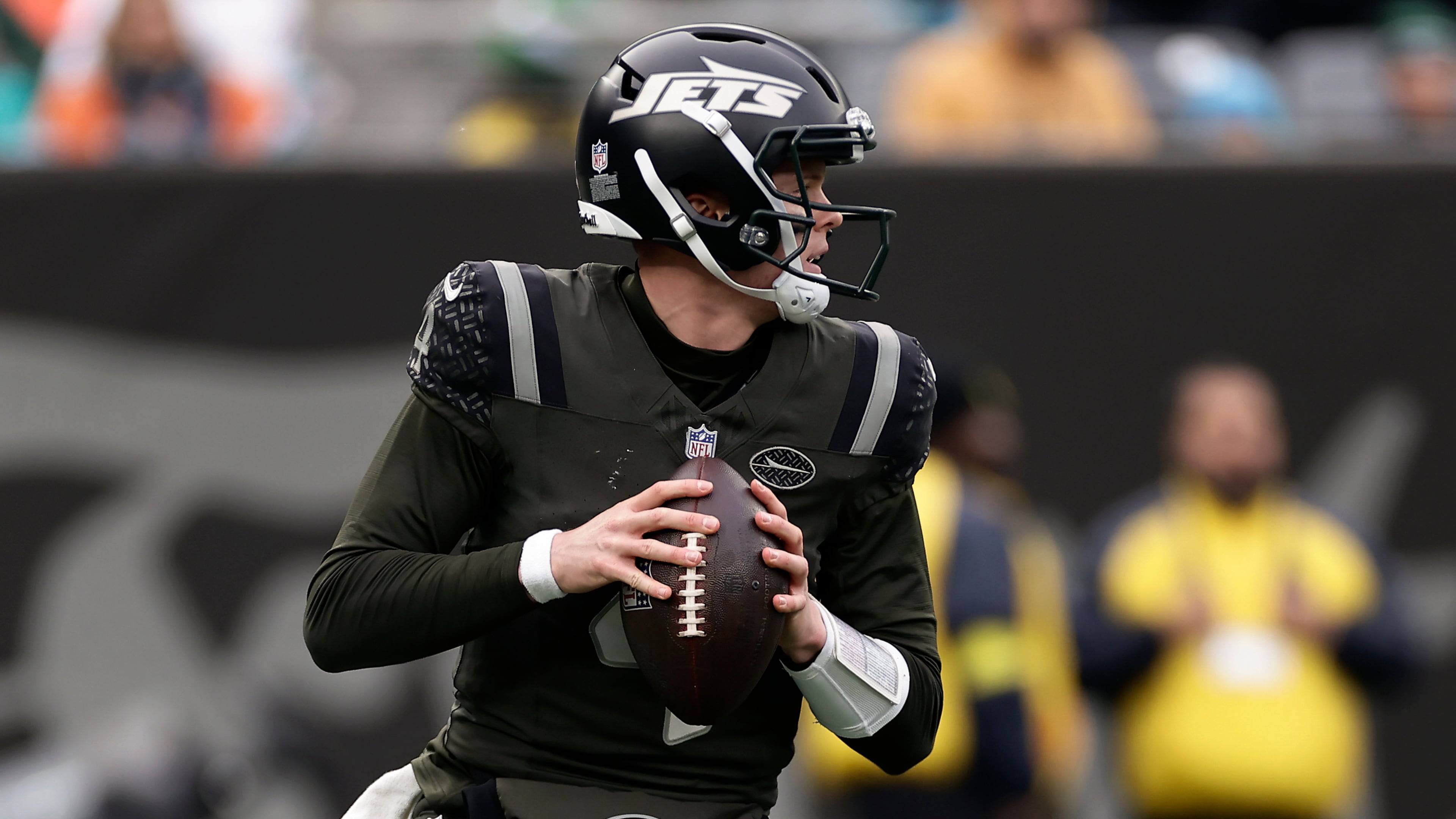 New York Jets quarterback Brady Cook (4) looks to pass against the Miami Dolphins during the second quarter of an NFL football game, Sunday, Dec. 7, 2025, in East Rutherford, N.J. (AP Photo/Adam Hunger)