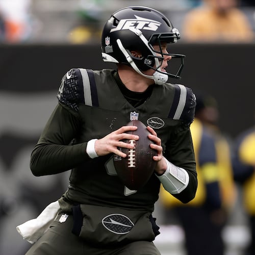 New York Jets quarterback Brady Cook (4) looks to pass against the Miami Dolphins during the second quarter of an NFL football game, Sunday, Dec. 7, 2025, in East Rutherford, N.J. (AP Photo/Adam Hunger)