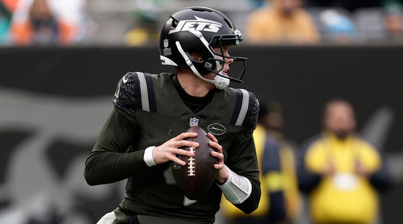 New York Jets quarterback Brady Cook (4) looks to pass against the Miami Dolphins during the second quarter of an NFL football game, Sunday, Dec. 7, 2025, in East Rutherford, N.J. (AP Photo/Adam Hunger)