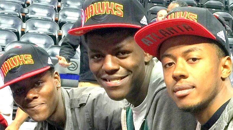Malachi Williams (left) enjoys an Atlanta Hawks game with his brother Johnny Manuel (center) and Givonti Youngblood, all of whom are in foster care. Manuel, 19, and Youngblood, 20, will soon age out of the system. CONTRIBUTED