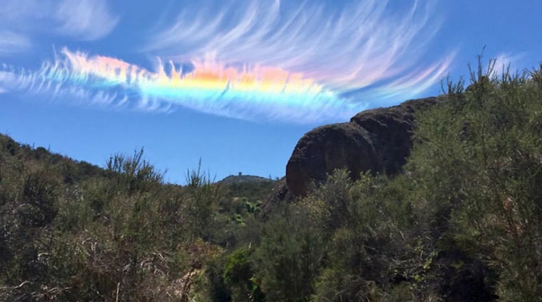 A photo of a dazzling fire rainbow above Pinnacles National Park in Central California this week that was taken by a jogger and sent to the National Weather Service.