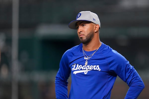 Los Angeles Dodgers designated hitter Eddie Rosario looks on prior to a baseball game against the Texas Rangers Friday, April 18, 2025, in Arlington, Texas. (AP Photo/Julio Cortez)