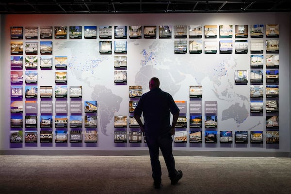 A visitor looks at a map displaying the locations of Apple stores worldwide at the "50 Years of Innovation from Apple" exhibit at the Mimms Museum in Roswell on Sunday, April 19, 2026.
 (Miguel Martinez/AJC)