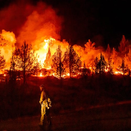 FILE - A firefighter monitors a firing operation while battling a wildfire called the Bench Fire in Warm Springs, Ore., July 25, 2026. (AP Photo/Noah Berger, File)