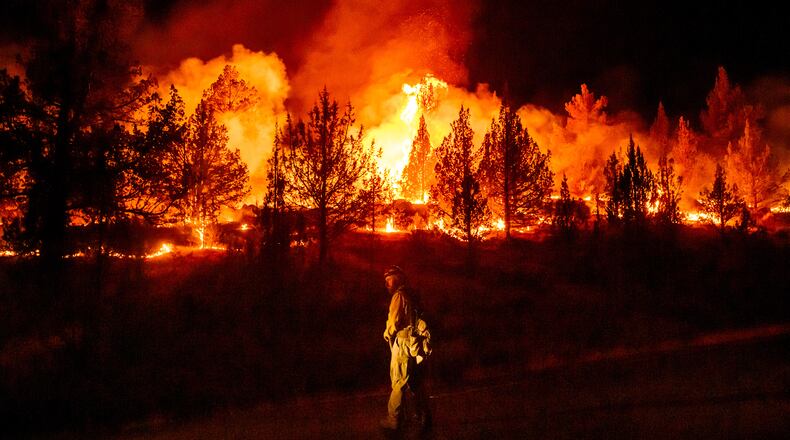 FILE - A firefighter monitors a firing operation while battling a wildfire called the Bench Fire in Warm Springs, Ore., July 25, 2026. (AP Photo/Noah Berger, File)