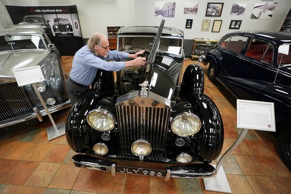 Tommy Tate opens the hood of a 1946 Rolls-Royce Silver Wraith during an interview at The Rolls-Royce Foundation in Mechanicsburg, Pa., Saturday, April 5, 2025. (AP Photo/Matt Rourke)