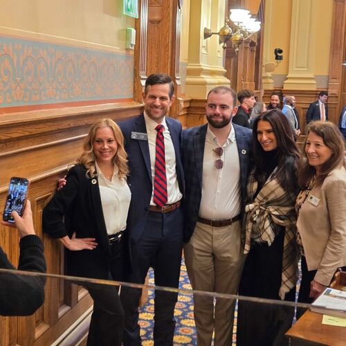 "Love on the Spectrum" star Connor Tomlinson (center) is urging Georgia lawmakers to pass a bill creating an autism specialty license plate and requiring first responders to be trained in autism response. From left: Layla Luna (autism advocate and founder of Just Bee), Sen. Brian Strickland, Connor Tomlinson, Lise Smith (Connor's mother) and Sharon Twaddell (COO of Just Bee). Taking the photo is Strickland's wife Lindsay. (Maya Prabhu/AJC)