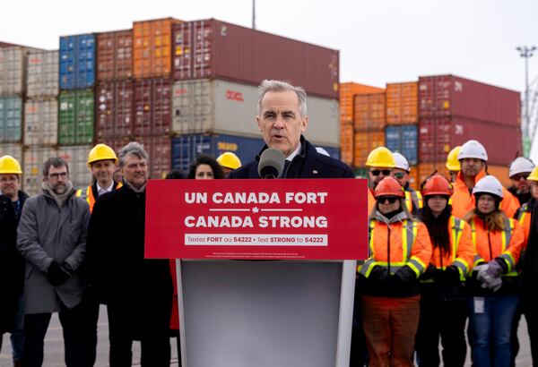 Liberal Leader Mark Carney greets workers as he arrives at a campaign event at the Port of Montreal on Friday March 28, 2025. (Frank Gunn/The Canadian Press via AP)