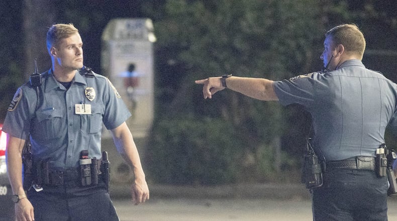 Gwinnett police officers work a crime scene near Stone Mountain on July 17, 2018. The Gwinnett County Police Department is in the process of rolling out body-worn cameras for all of its officers. ALYSSA POINTER/ALYSSA.POINTER@AJC.COM