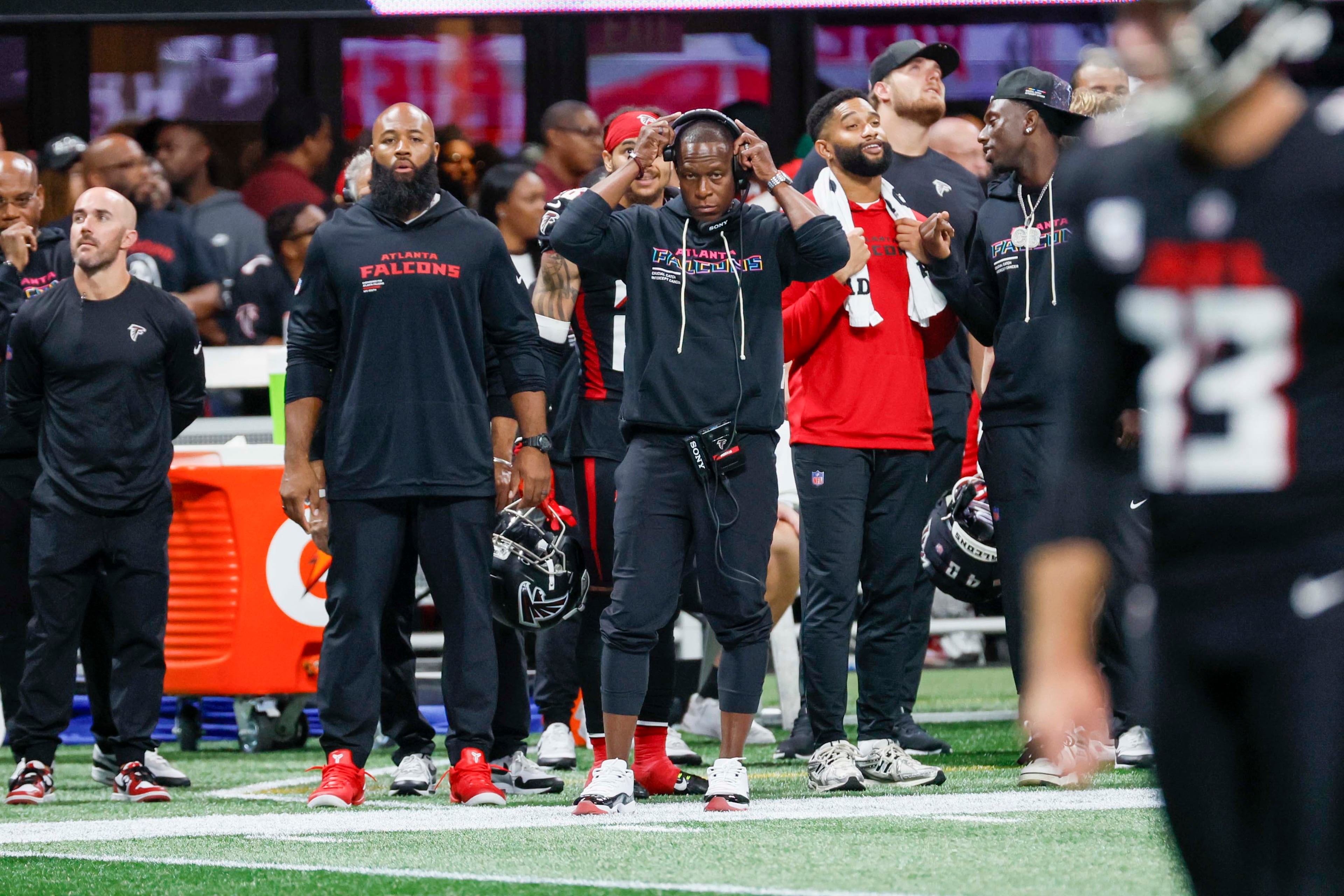 Atlanta head coach Raheem Morris adjusts his headphones during the second half of an NFL game against the Washington Commanders at Mercedes-Benz Stadium in Atlanta on Sunday, September 28, 2025. (Miguel Martinez/AJC)