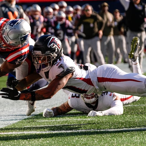 New England Patriots wide receiver Stefon Diggs (8) scores a touchdown against Atlanta Falcons cornerback Mike Hughes (21) during the first half of an NFL football game, Sunday, Nov. 2, 2025, in Foxborough, Mass. (AP Photo/Charles Krupa)