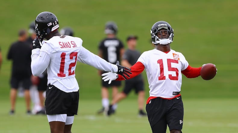 Mohamed Sanu gives Christian Blake five after he catches a pass from Matt Ryan on the first day of mandatory mini-camp on Tuesday, June 12, 2018, in Flowery Branch. Curtis Compton/ccompton@ajc.com