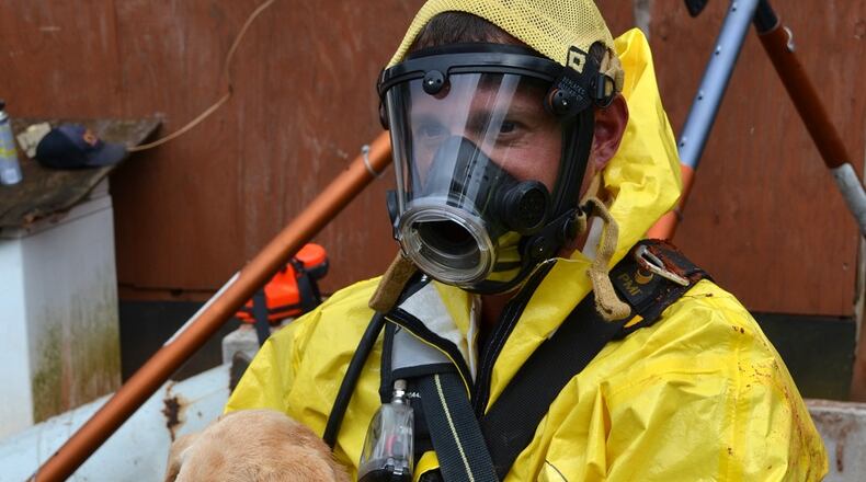 Cherokee County firefighters, including Brendan O’Brian, rescued a yellow lab puppy from a 75-foot well Sunday morning. (Credit: Cherokee County Fire and Emergency Services)