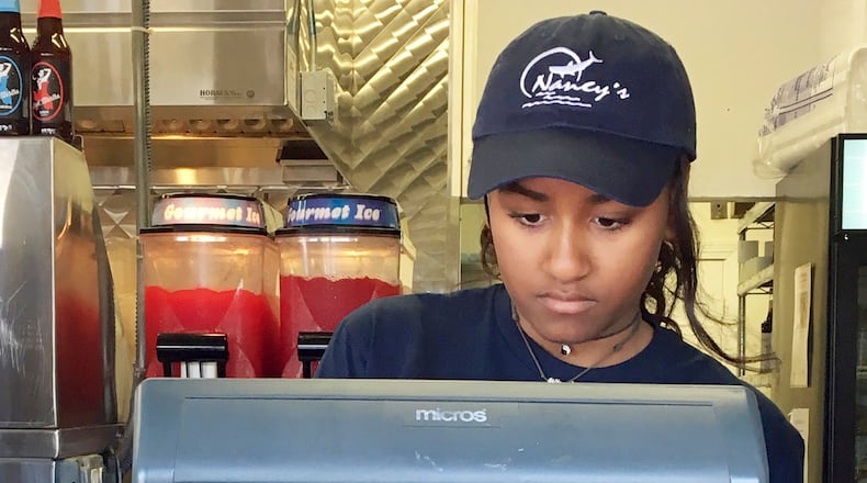 Sasha Obama, daughter of President Barack Obama, works the register at Nancy's Restaurant in Oak Bluffs, Mass., on the island of Martha's Vineyard. (Boston Herald, Christopher Evans via AP)