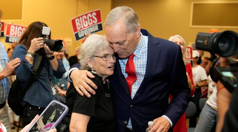 Rep. Andy Biggs, right, R-Ariz., who is running in the primary for Arizona governor, hugs a supporter at a campaign event, Friday, July 17, 2026, in Gilbert, Ariz. (AP Photo/Ross D. Franklin)
