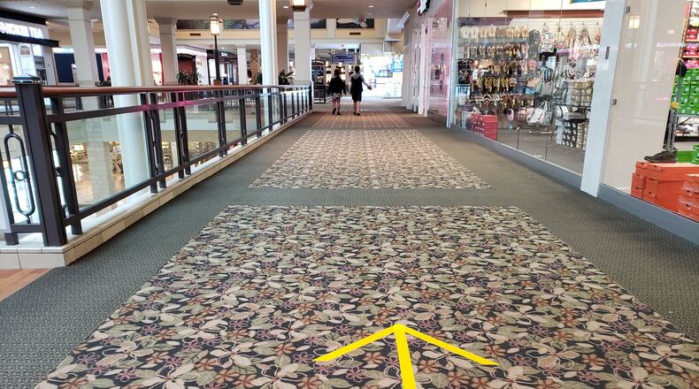 The Mall of Georgia in Gwinnett County and other metro Atlanta malls have re-started operations with new safety measures in places during the coronavirus pandemic. Among the steps to encourage social distancing: marking some aisles for walking in only one direction. MATT KEMPNER / AJC