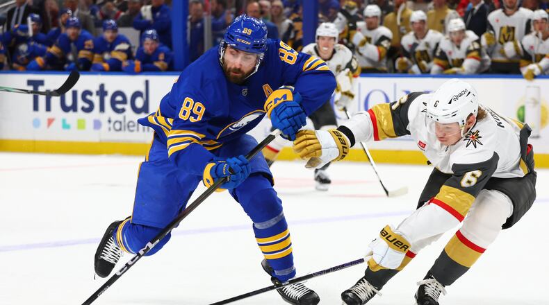FILE - Buffalo Sabres right wing Alex Tuch (89) is stick checked by Vegas Golden Knights defenseman Kaedan Korczak (6) during the first period of an NHL hockey game, March 3, 2026, in Buffalo, N.Y. (AP Photo/Jeffrey T. Barnes, File)