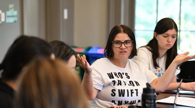 Emory University assistant professor Devon Goss developed a sociology class centered around Taylor Swift at Emory University's Oxford campus. She's wearing a t-shirt that says, "Who's Taylor Swift Anyway? Ew." Swift wore a similar shirt on tour recently. (Hyosub Shin / AJC)