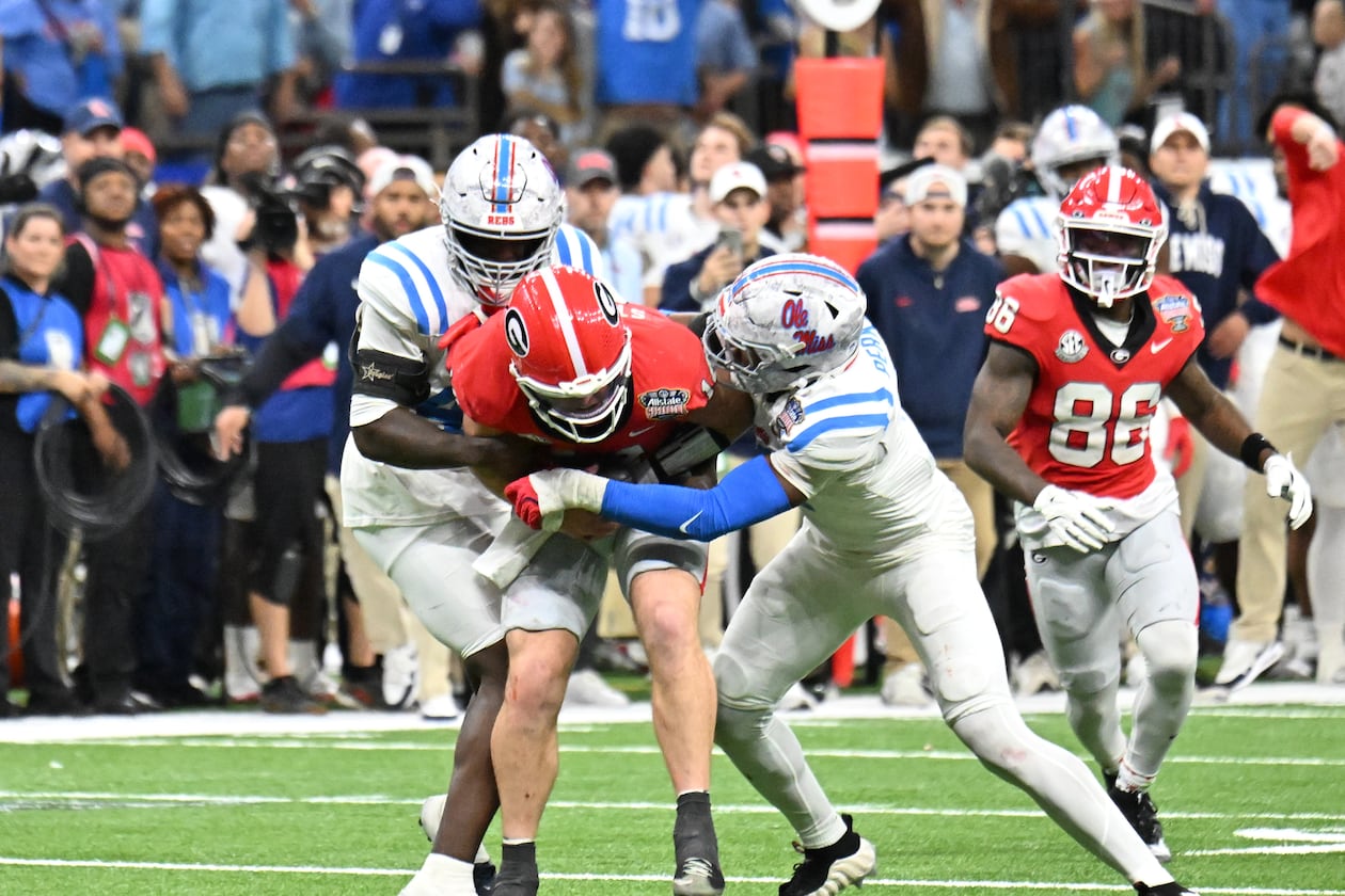 One former NFL scout said of Georgia quarterback Gunner Stockton (center), pictured being tackled against Ole Miss in the Sugar Bowl College Football Playoff game in January: "He’s a talented kid and a great leader, but we have to see if the traits equate to the NFL.” (Hyosub Shin/AJC)